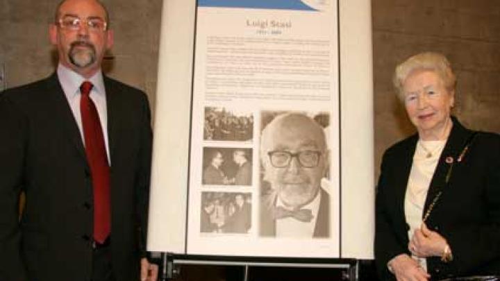 Luigi Stasi's son and widow next to a memorial plaque that will be placed at the entrance to the Luigi Stasi Seminar Room. 