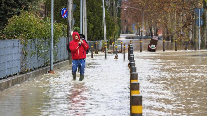 Man walking on a flooded road