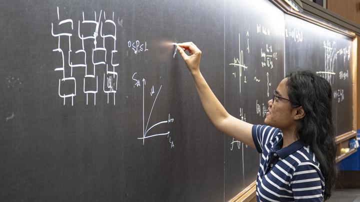 Poetri Tarabunga writing on the blackboard