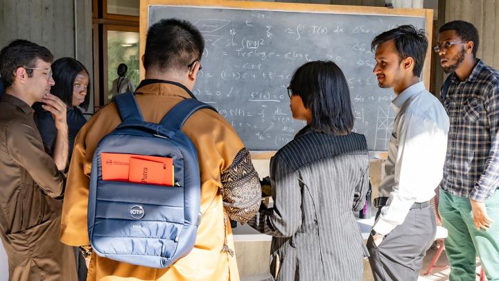 students in front of blackboard